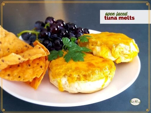 tuna melt sandwich on a plate with chips and grapes and a text overlay "open faced tuna melts"