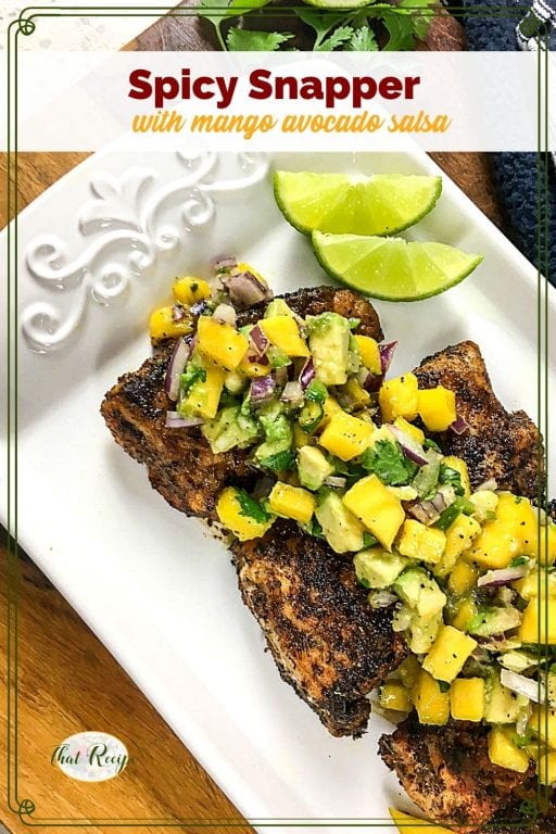 cajun snapper on a serving plate topped with mango salsa and text overlay "spicy snapper with mango avocado salsa"