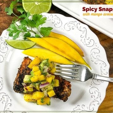 cajun snapper on a plate topped with mango salsa and text overlay "spicy snapper with mango avocado salsa"