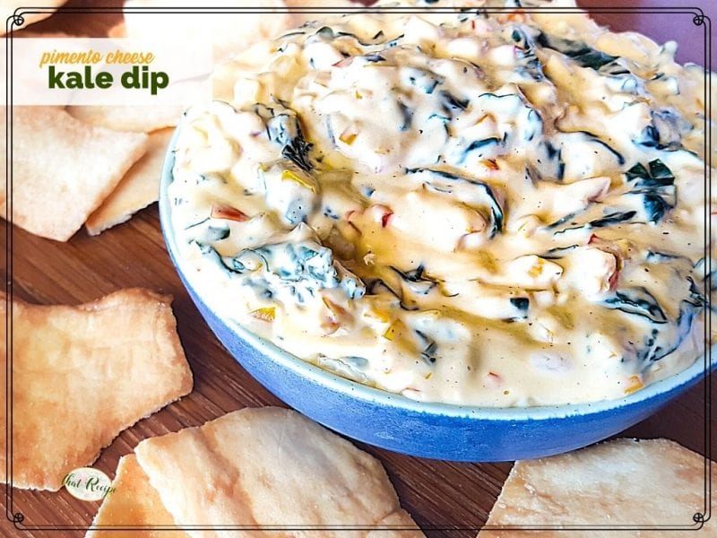 bowl of dip on a table surrounded by chips and text overlay "pimento cheese kale dip"