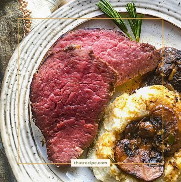 top down view of slice of beef with potatoes and mushrooms on a plate