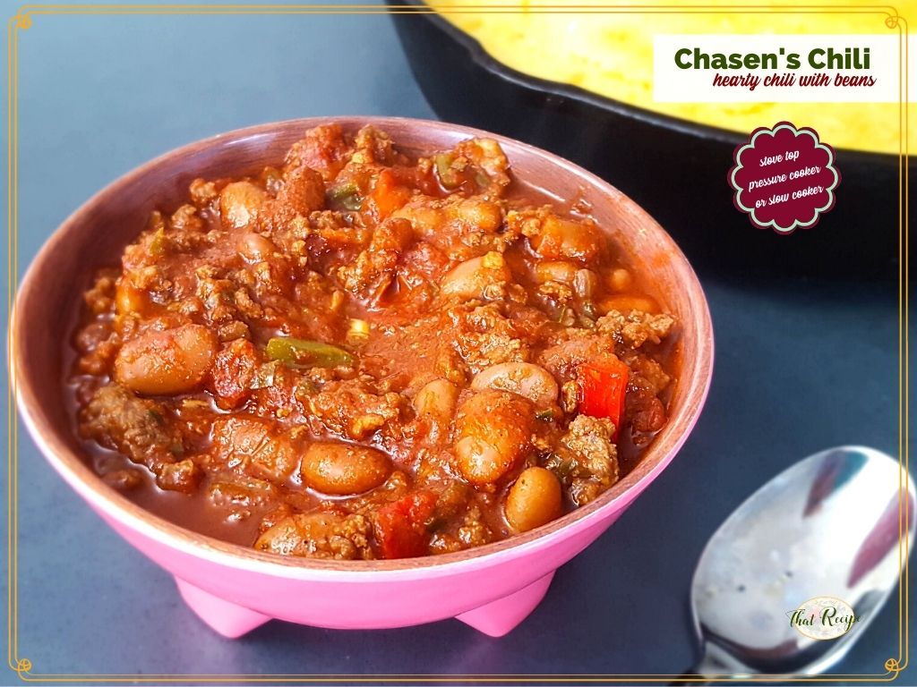 bowl of chili in front of pan of cornbred with text overlay "Chasen's Chili hearty chili with meat stove top, pressure cooker or slow cooker"