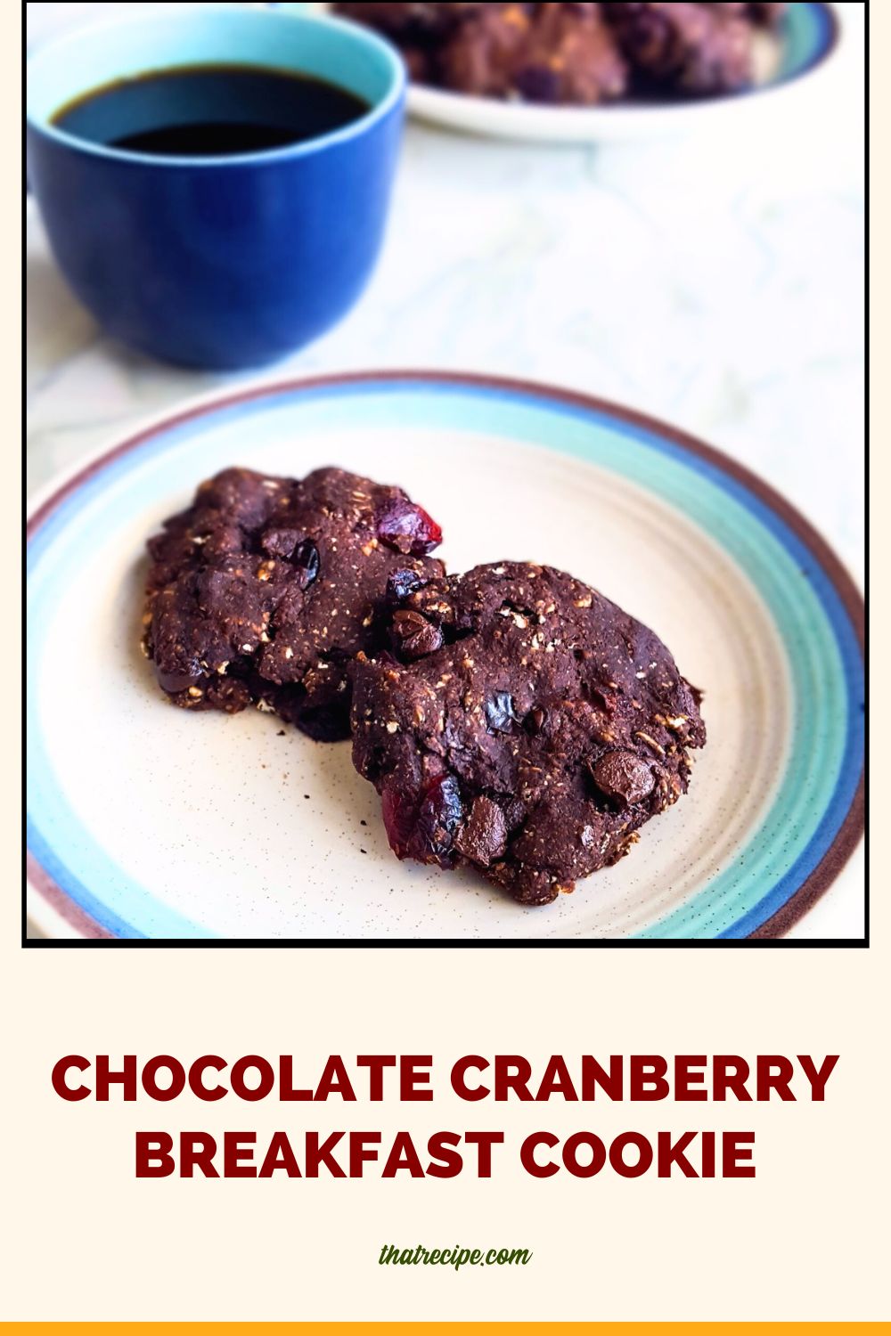 two chocolate cookies on a plate with a cup of coffee next to it and text overlay "Chocolate cranberry breakfast cookies"