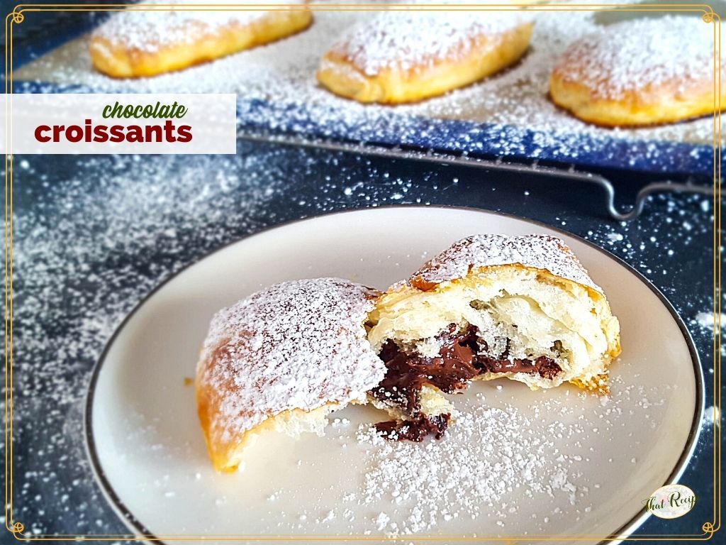 Chocolate croissant broken open on a plate