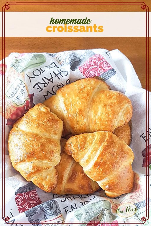 top down view of croissants in a basket with text overlay "homemade croissants"