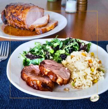 plate with pork tenderloin, brown rice and salad