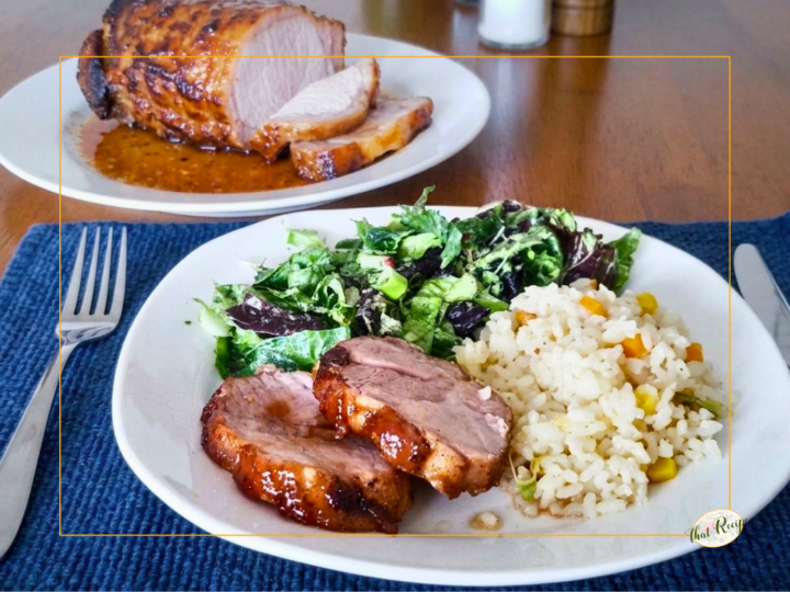 plate with pork tenderloin, brown rice and salad