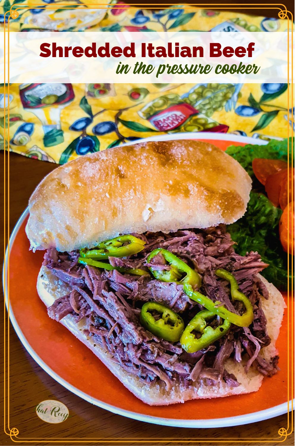 shredded beef sandwich on a plate with lettuce, tomatoes and peppers with text overlay "Shredded Italian Beef in the pressure cooker"