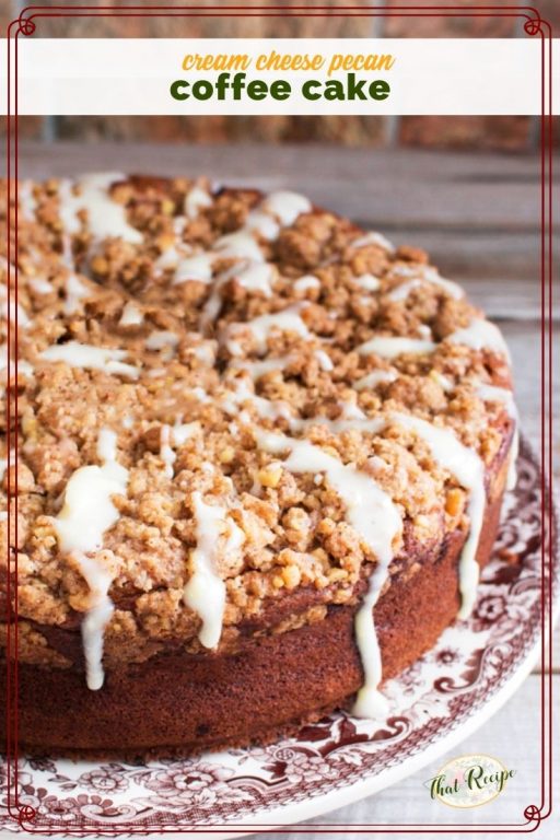 coffee cake with streusel topping and glaze on a plate with text overlay "pecan cream cheese coffee cake"