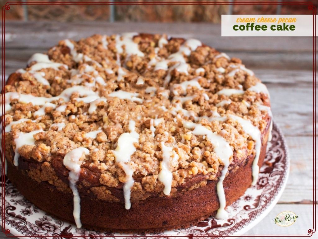 coffee cake with streusel topping and glaze on a plate with text overlay "pecan cream cheese coffee cake"