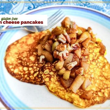 pancakes on a plate topped with pears and nuts with text overlay "keto gluten free Cream Cheese Pancakes"