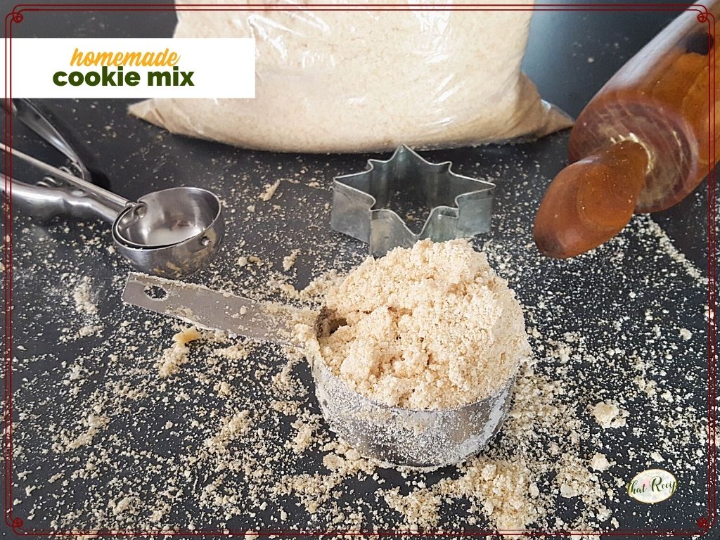 cup of cookie mix on a counter with cookie scoop and rolling pin and text overlay "homemade cookie mix"