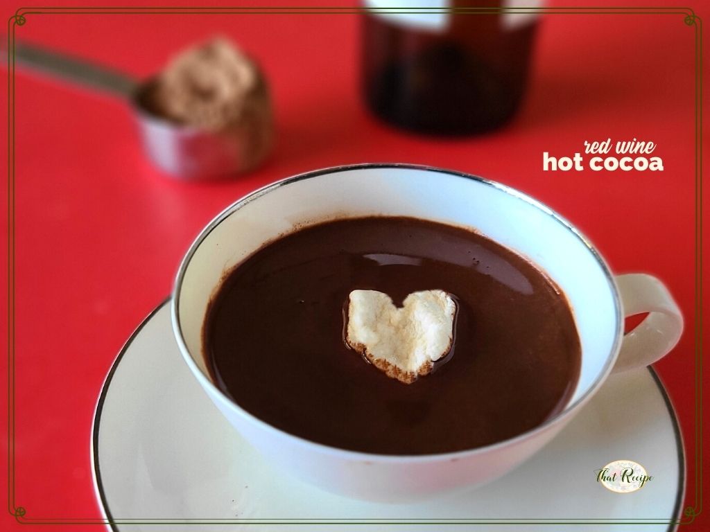 cup of cocoa with heart shaped marshmallow and text overlay "red wine hot cocoa"