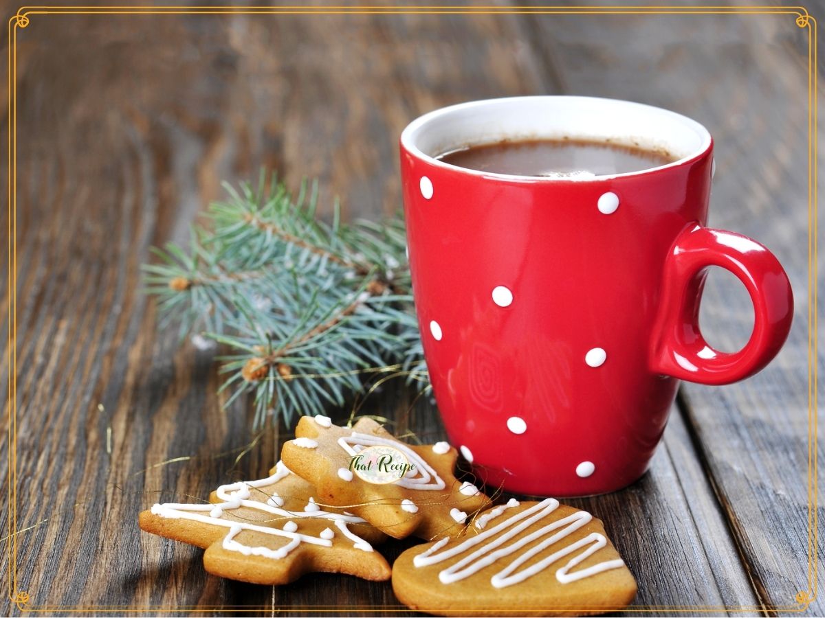 mug of cocoa with with cookies on a table