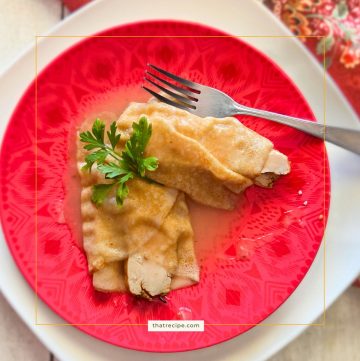 turkey crepes covered in turkey gravy on a plate