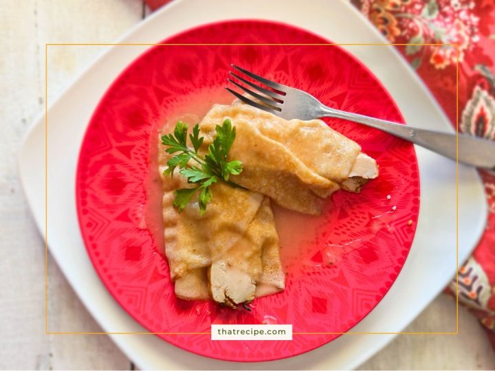 turkey crepes covered in turkey gravy on a plate