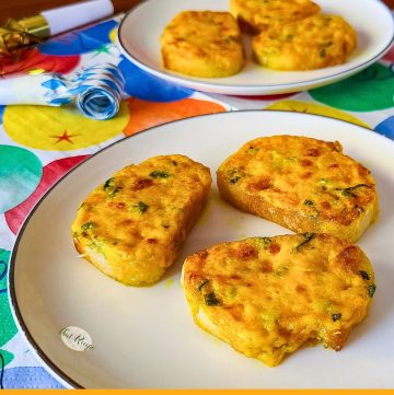 mini cheese appetizers on a plate with text overlay "Curry Cheese Toasts"