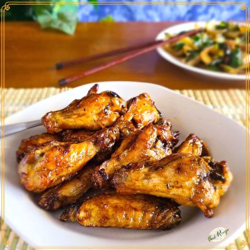 glazed chicken wings on a plate with text overlay "air fryer teriyaki chicken wings"