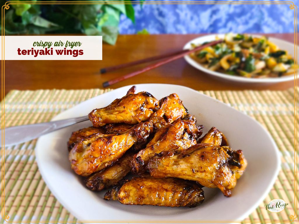 glazed chicken wings on a plate with text overlay "air fryer teriyaki chicken wings"