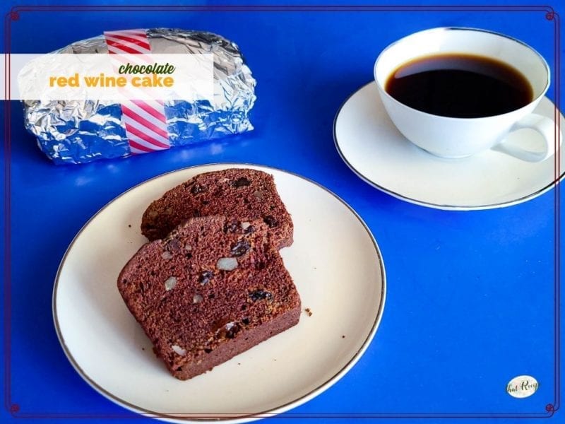 slices of chocolate loaf cake on a plate with foil wrapped loaf and coffee and text overlay "chocolate red wine cake"