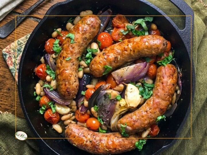 top down view of italian sausages and beans in a cast iron skillet