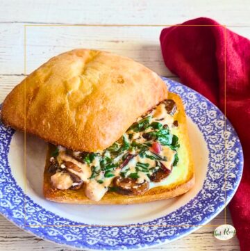 Grilled cheese sandwich made with chard and mushrooms on a ciabatta roll.