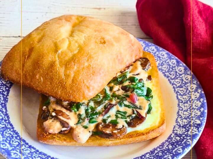 Grilled cheese sandwich made with chard and mushrooms on a ciabatta roll.