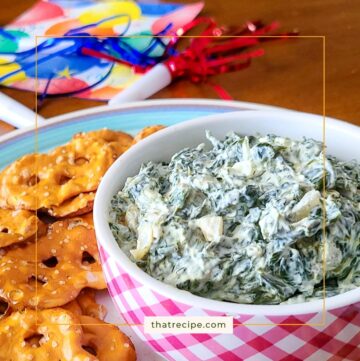 spinach dip in a bowl with pretzel crackers around it