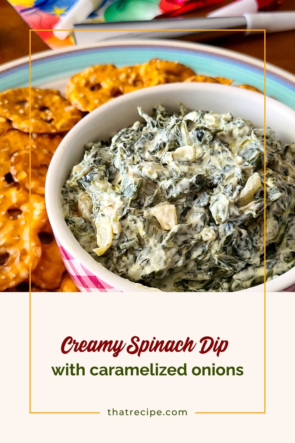 spinach dip in a bowl with pretzel crackers around it