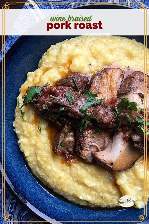 top down view of pork slices on polenta with text overlay "wine braised pork roast"