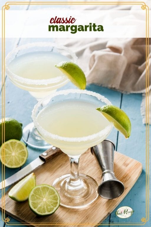 margarita in a glass surrounded by cut limes with text overlay "classic margarita"