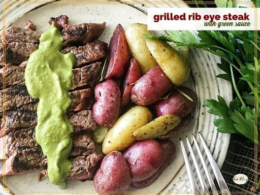top down view potatoes and steak with sauce and text overlay "grilled rib eye with green sauce"