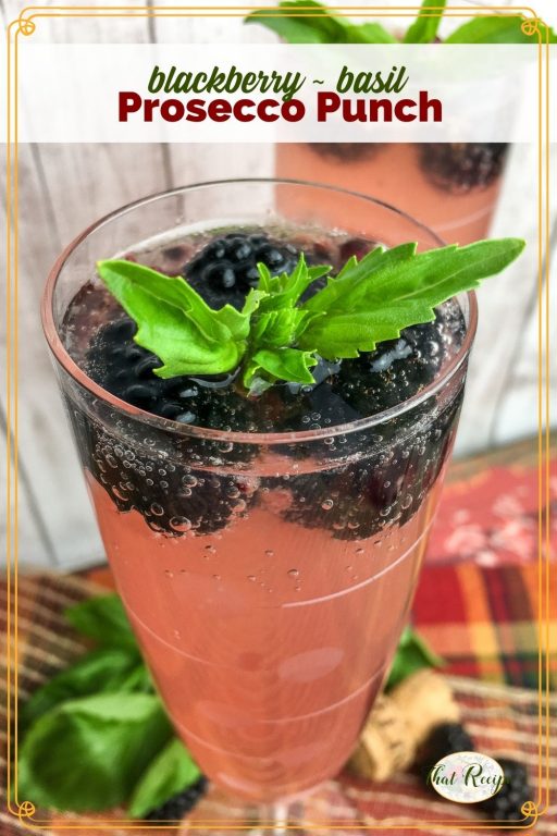 sparkling cocktails in champagne flutes with text "blackberry basil prosecco punch"