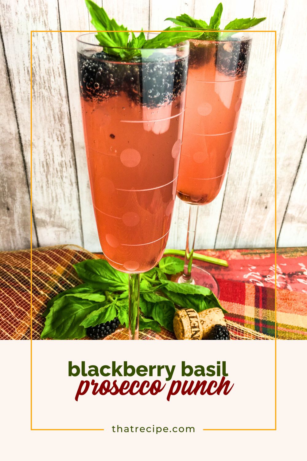 glass of pink sparkling punch with blackberries and basil