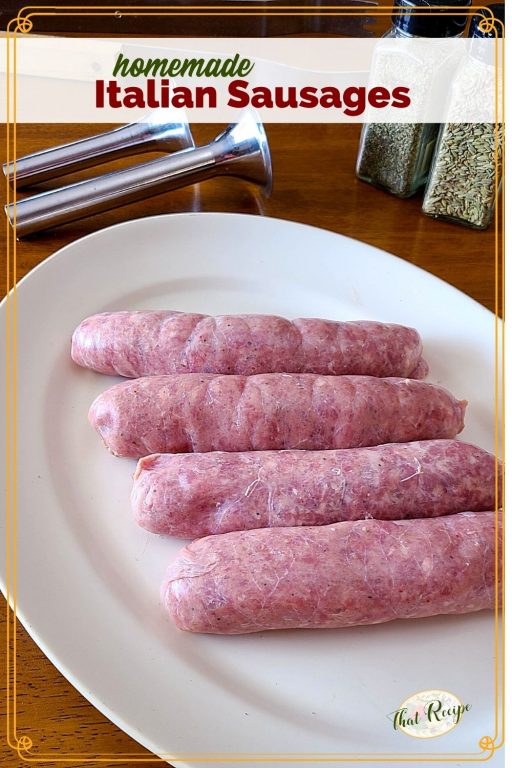 Homemade sausages on a plate with sausage making tools and herbs and text overlay "Homemade Italian Sausages"