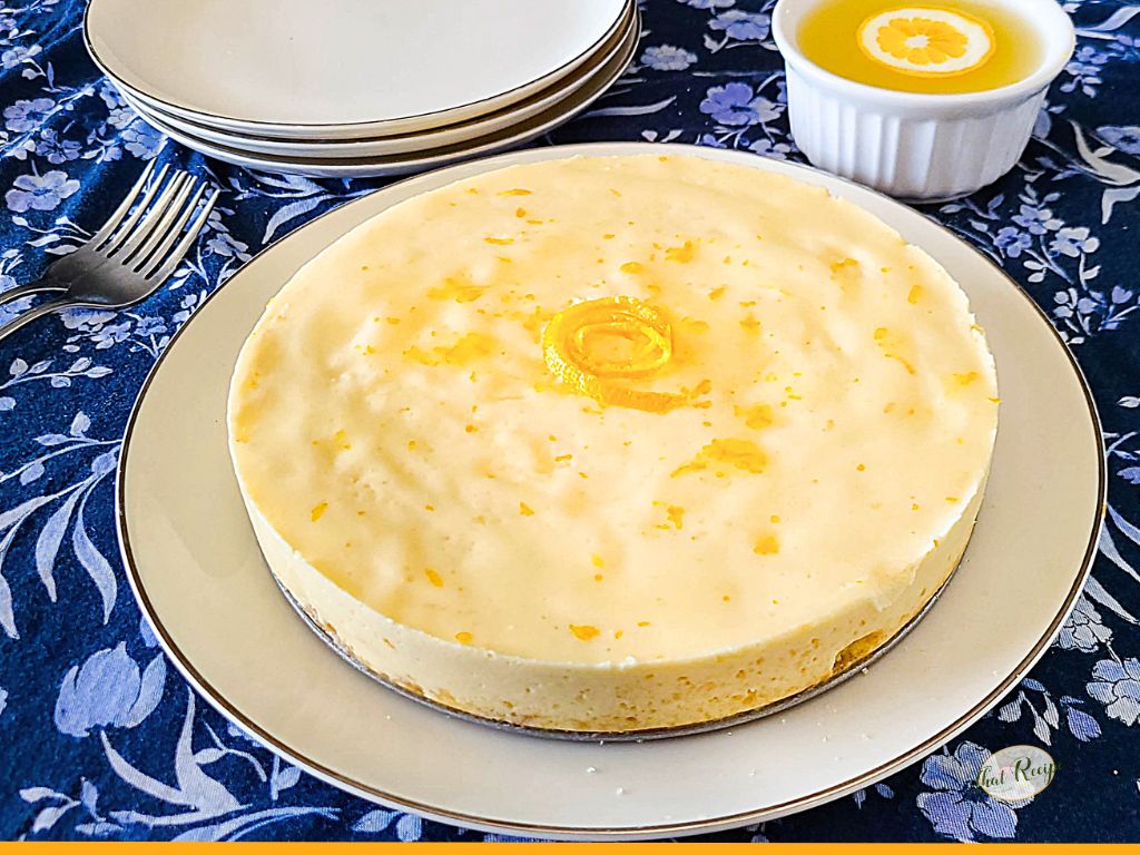 homemade cheesecake on a plate with text overlay "lemon ricotta cheesecake"