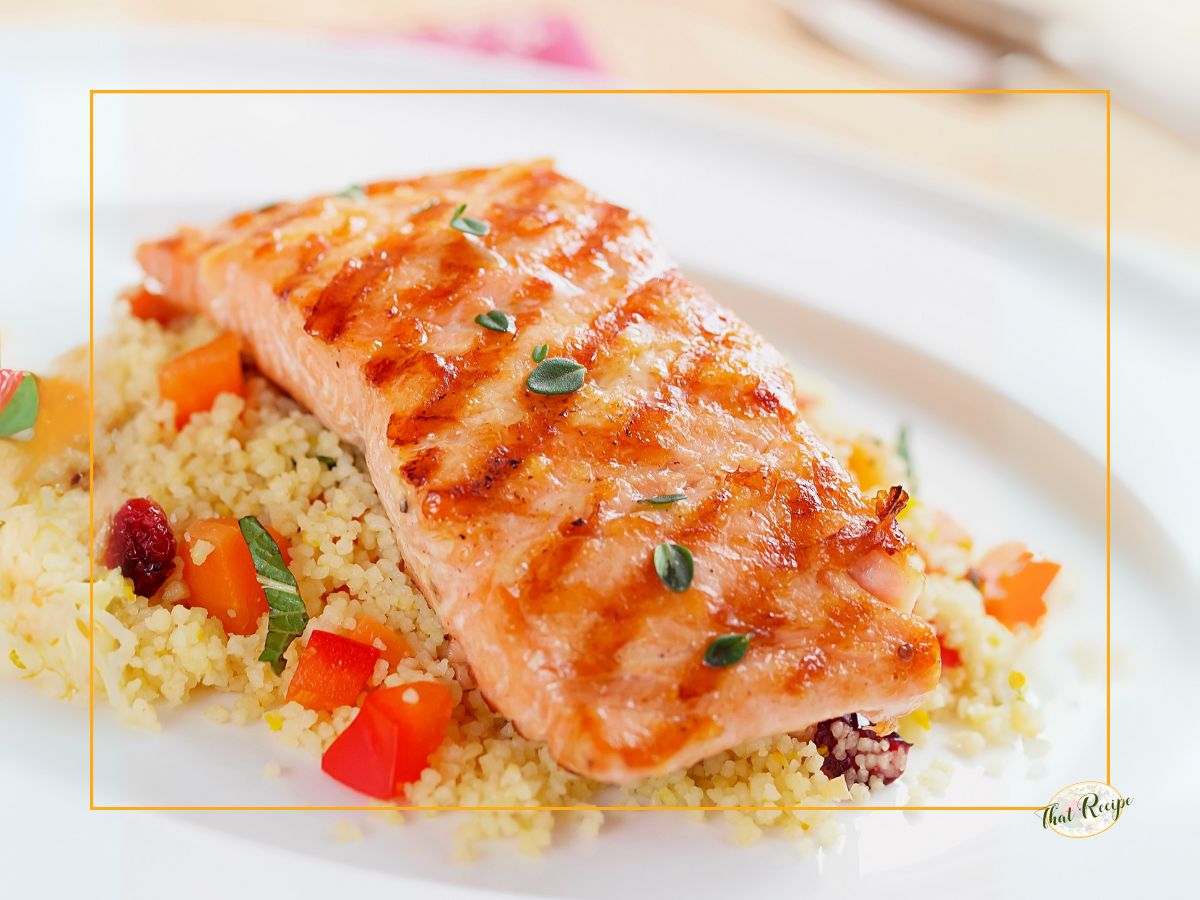 grilled salmon on a plate with couscous