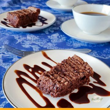slice of chocolate torte on a plate drizzled in chocolate sauce with text overlay "Hungarian chocolate torte"