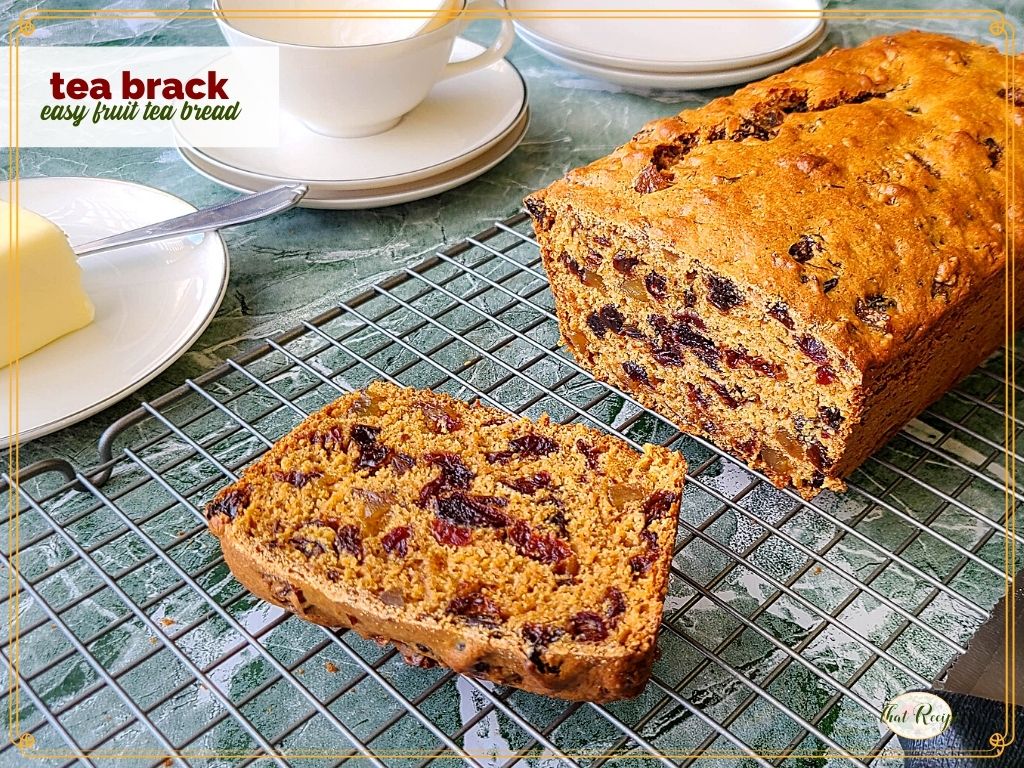 loaf of fruit bread on a cooling rack with text overlay "Tea Brack, easy fruit tea bread"