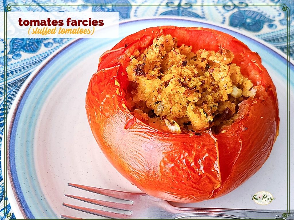 stuffed tomato on a plate with text overlay "tomates farcies"