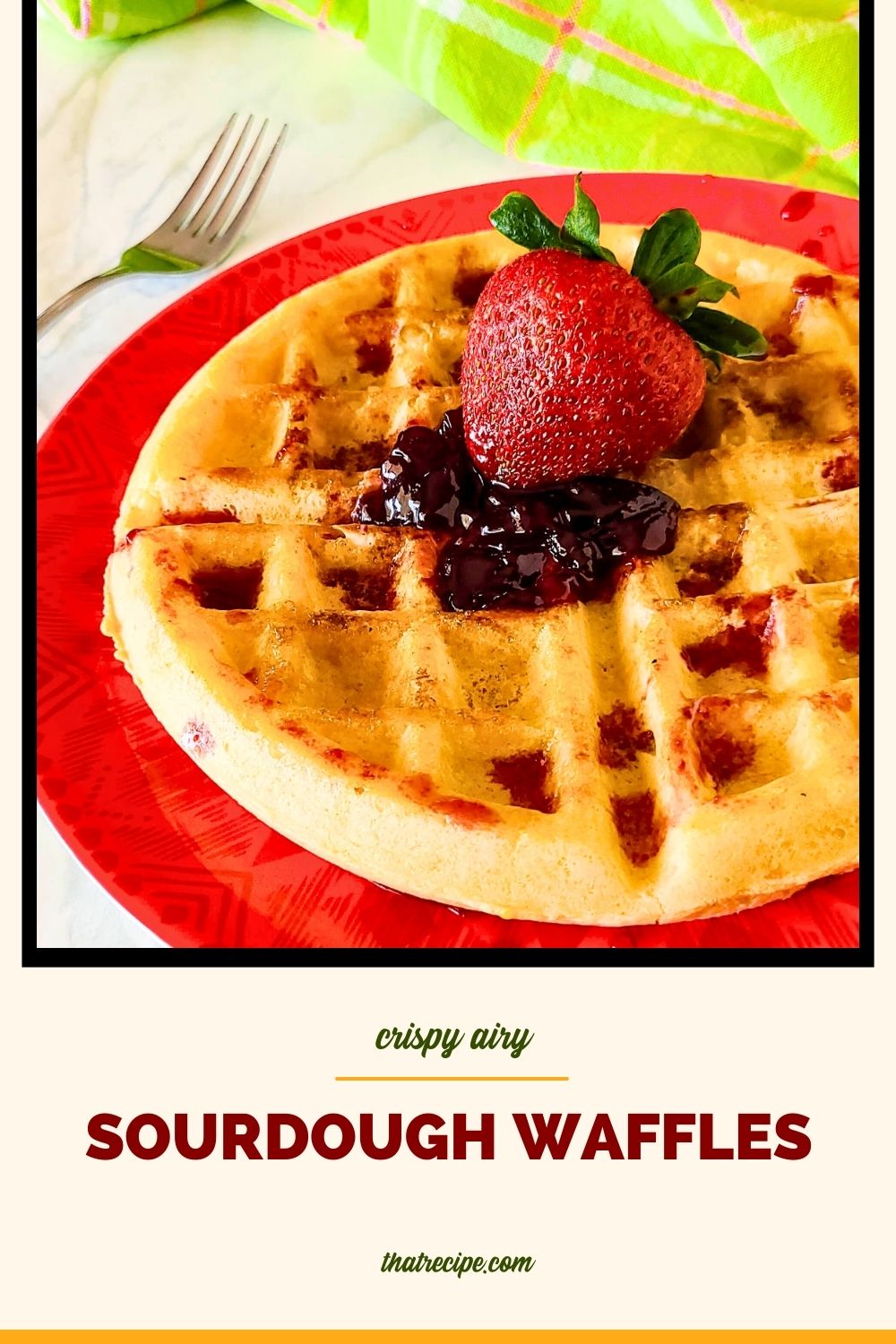 waffle topped with strawberry and jam and text overlay "crispy homemade sourdough waffles"