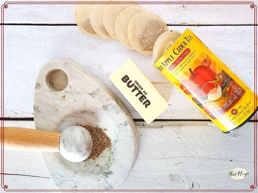 butter and hot apple cider tea on a table with mortar and pestle.