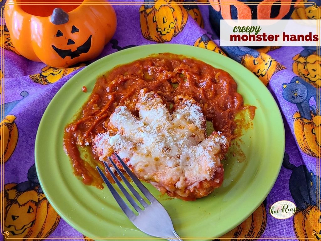 chicken breast cut into a hand on a plate of tomato sauce with text overlay "creepy monster hands"