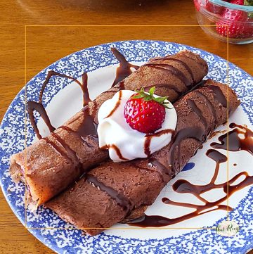 chocolate crepes with strawberries and whipped cream