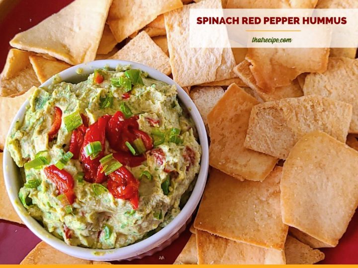 green and red hummus in a bowl with pita chips and text overlay "spinach and red pepper hummus"