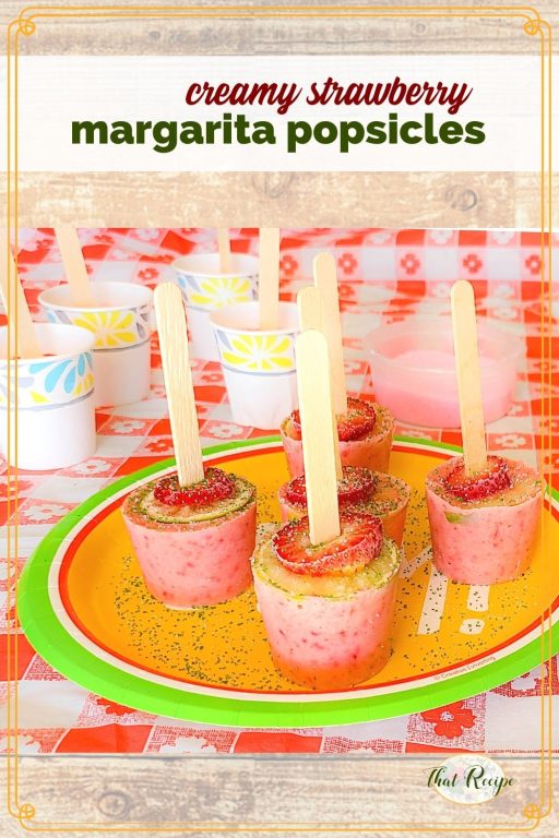 strawberry popsicles on a plate with text overrlay "creamy strawberry margarita popsicles"