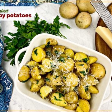 bowl of potato halves with text overlay "herbed baby potatoes"