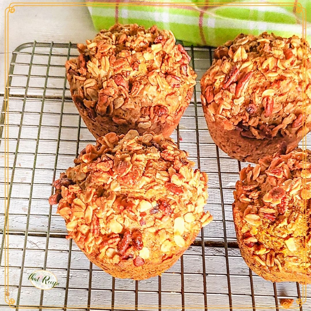carrot muffins topped with granola on a cooling rack