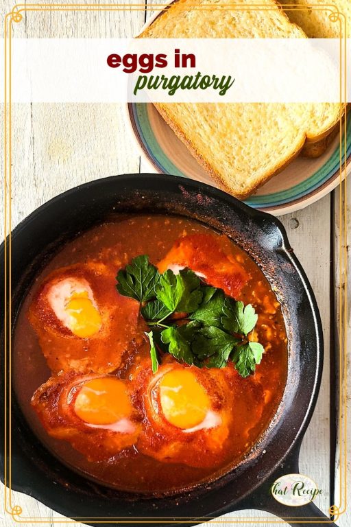 cast iron skillet with eggs in tomato sauce and text overlay "eggs in purgatory"
