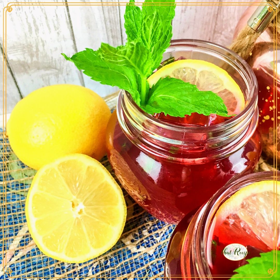 hibiscus tea in a glass with lemons and text overlay "passion tea lemonade"